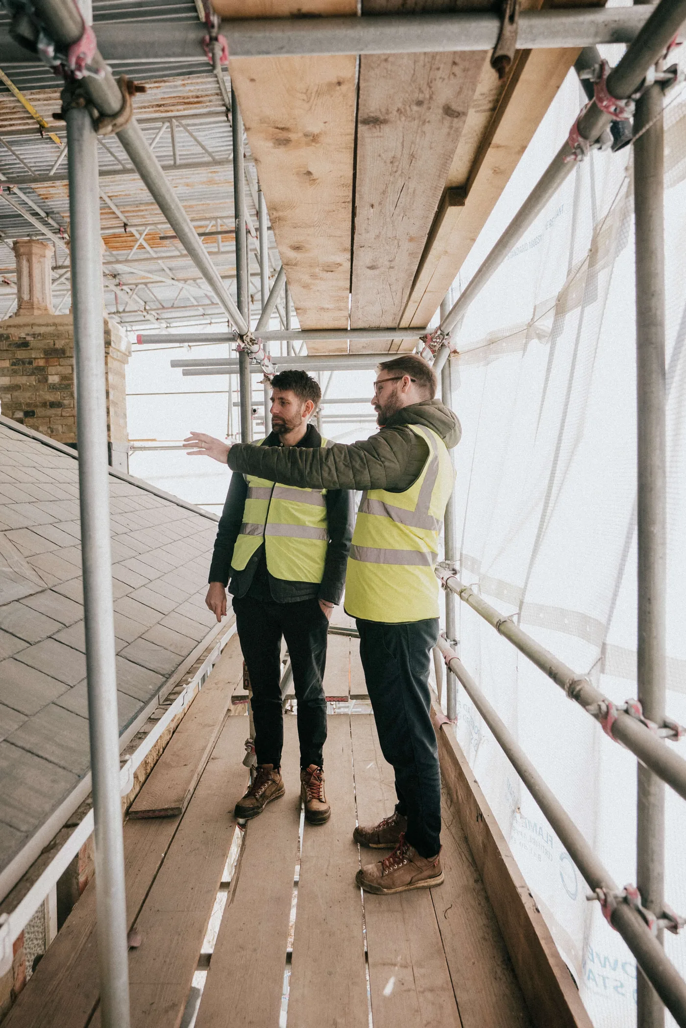 Danny Knox and Tim Howell on site Danny Knox and Tim Howell reviewing a project from the scaffolding on site