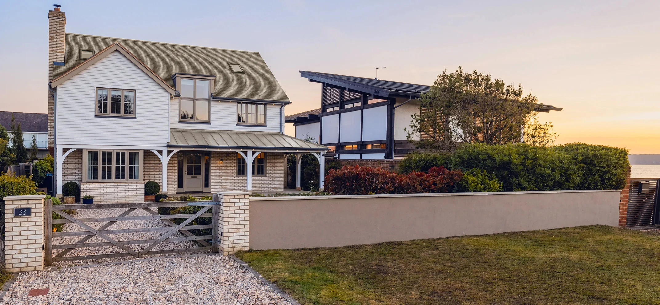 CGI render of the front elevation at Beachfield, Bembridge, a veranda porch and brick base below white weatherboarding, seen from the coast road CGI render of the front elevation at Beachfield, Bembridge, a veranda porch and brick base below white weatherboarding, seen from the coast road